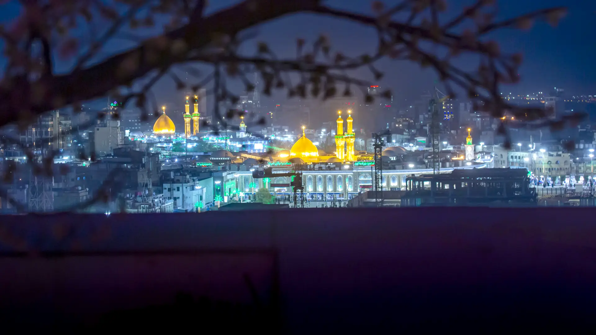 The golden domes of the shrines of Imam Hussain (a.s) and Hazrat Abbas (a.s) lit up at night in Karbala